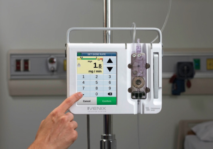 persons finger touching infusion pump buttons on screen