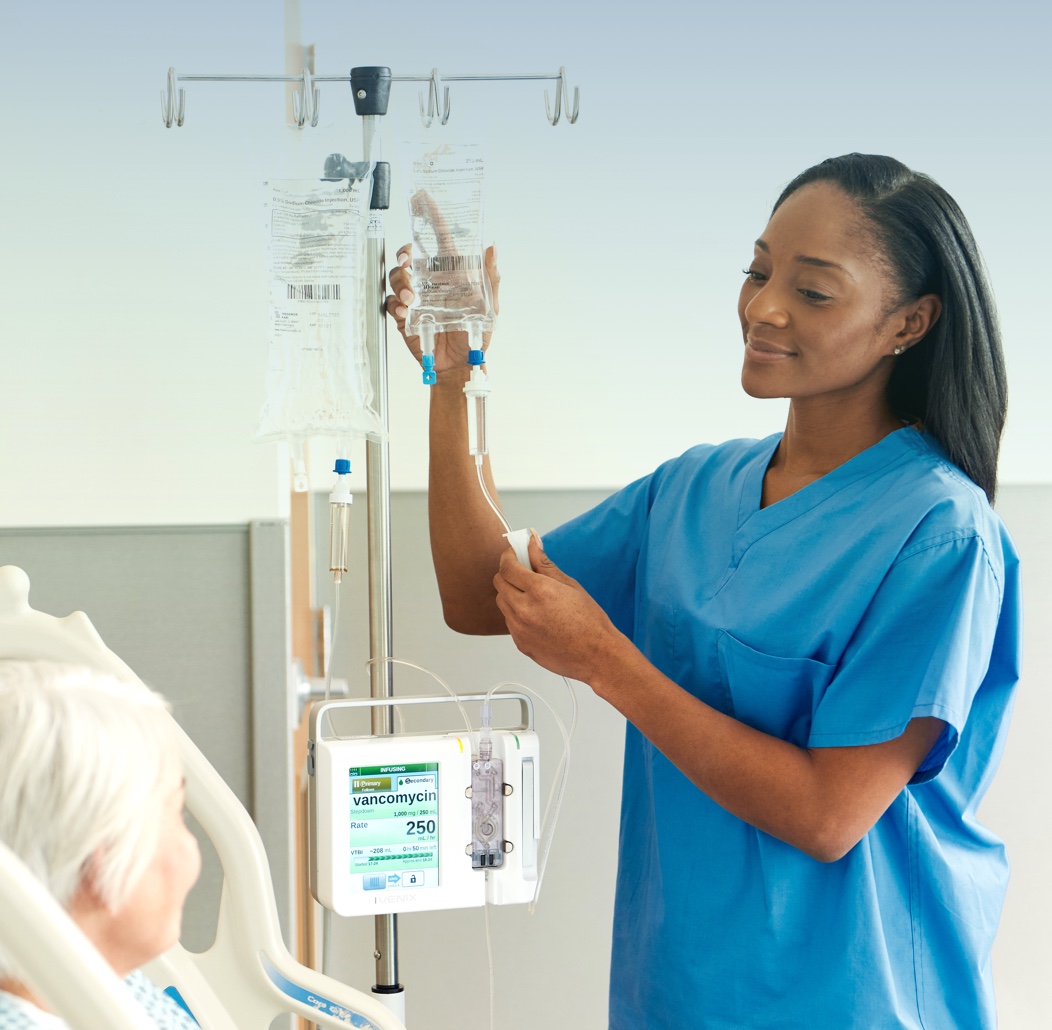 Nurse Assisting Patient with IV and Ivenix Infusion System Portrait
